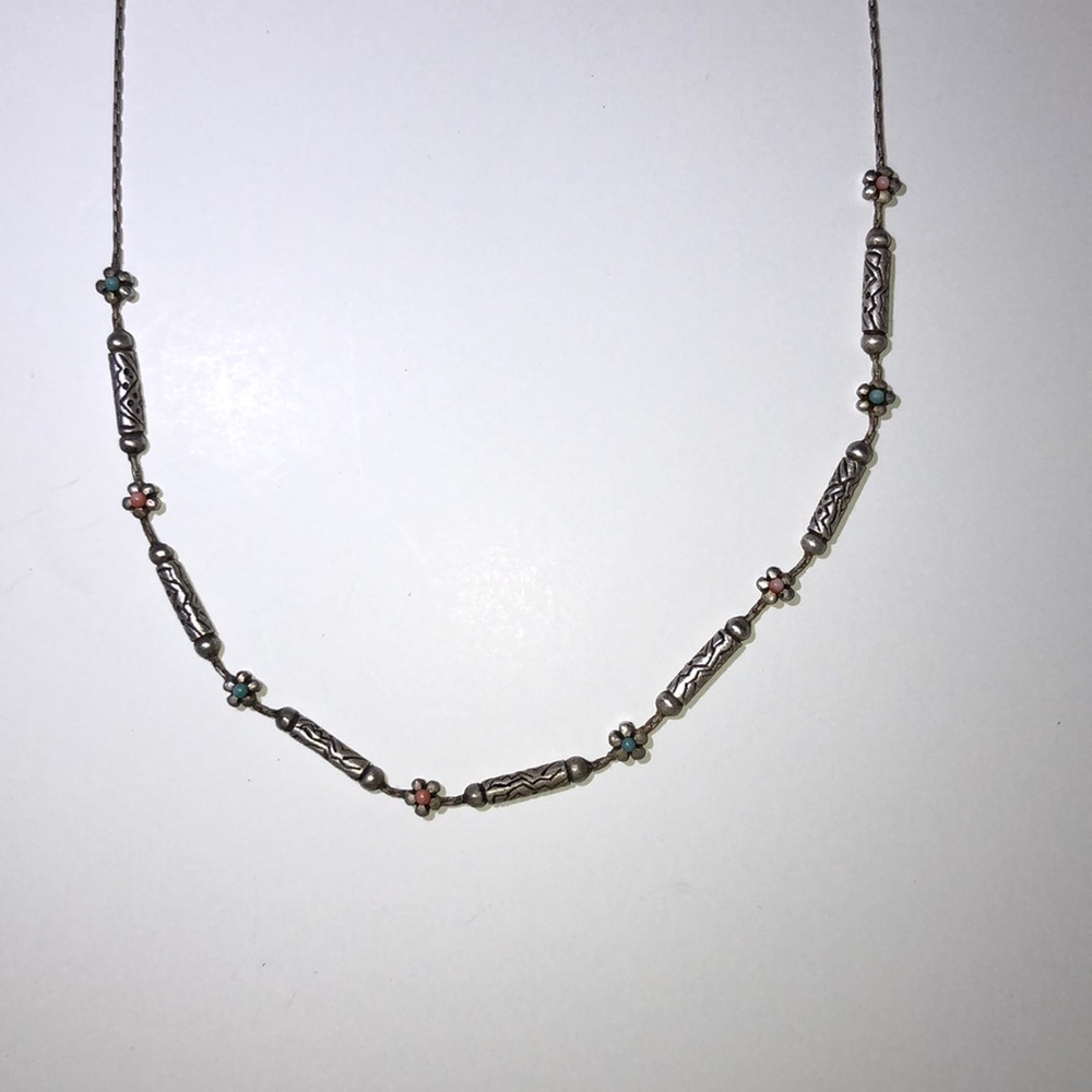 Silver chain and bead necklace.